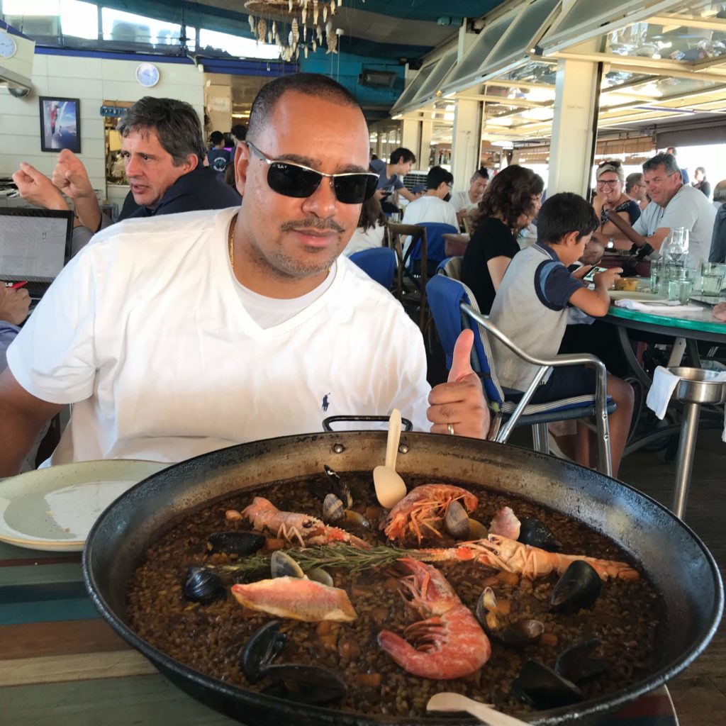 Man enjoying large bowl of paella