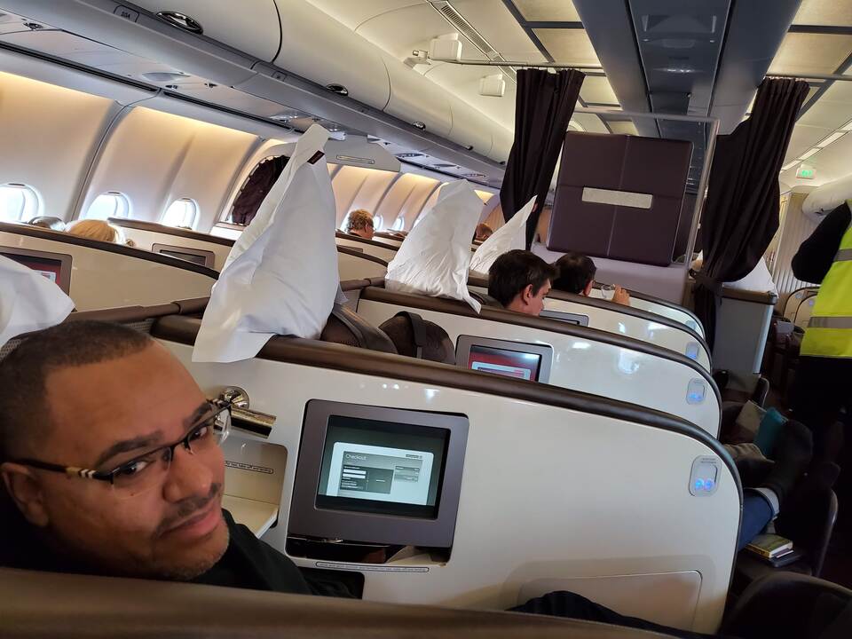 Man in upper class seat on airplane