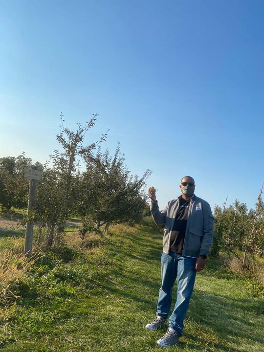 Calvin Tilokee picking apples at Fishkill farms